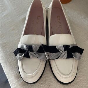 Kate Spade Cream Loafers with Black and Gray Bow Leandra patent leather loafer.